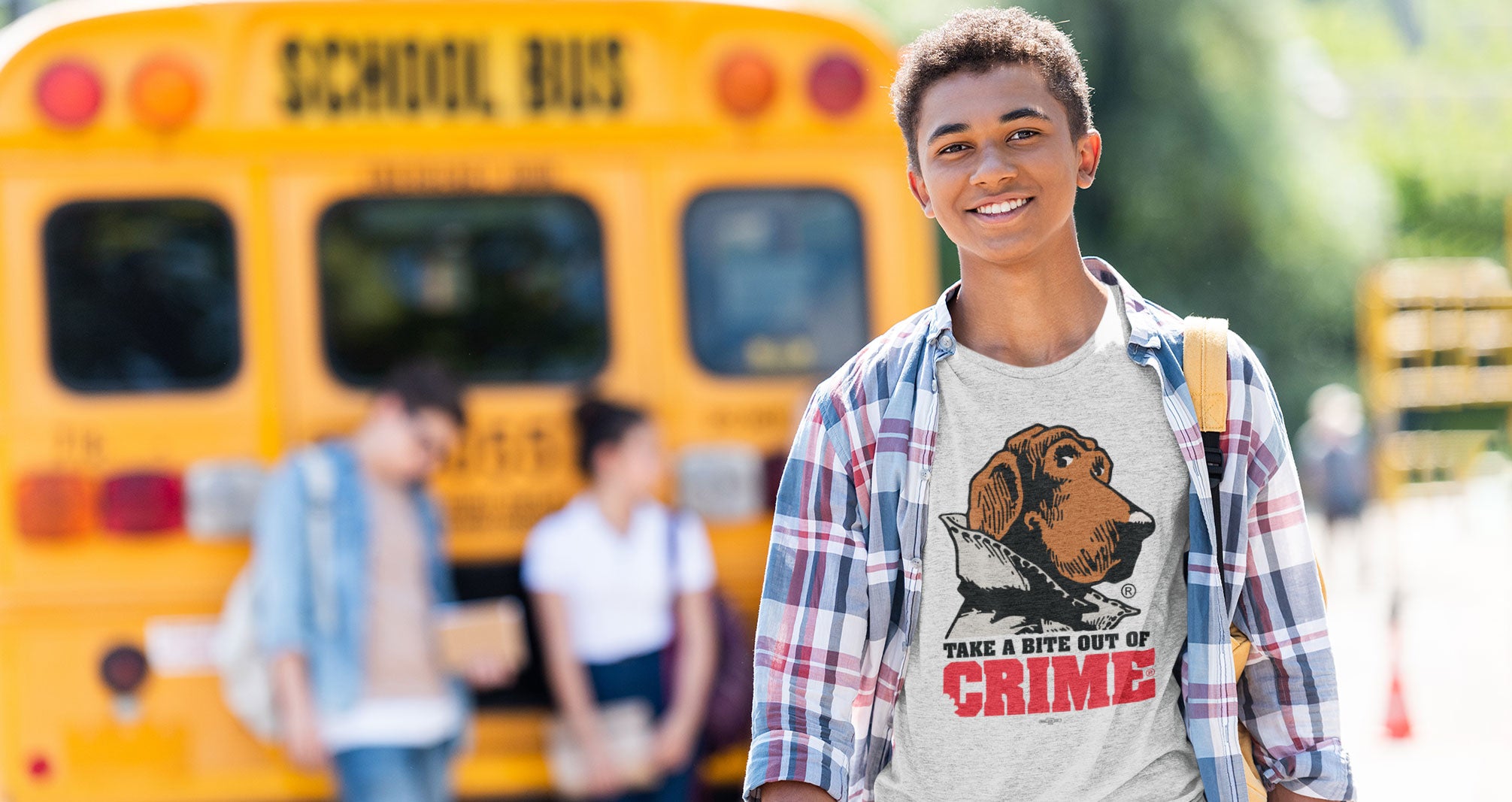 boy standing behind school bus